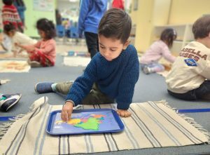 A boy in a Pleasanton California kindergarten, learning.