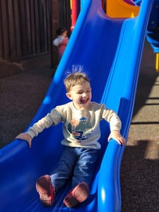 a child going down the slide at Montessori plus STEM approach at the new San Carlos, California, preschool