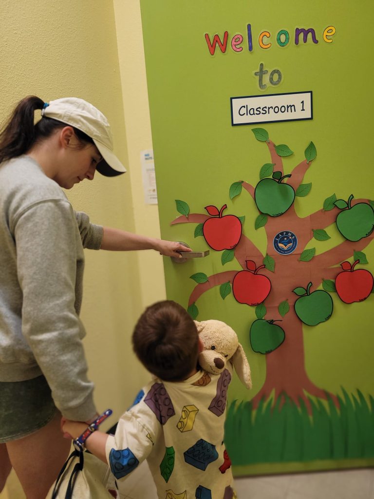 Fall back to school to preschool, daycare, and childcare in Fremont, Dublin, and Danville, California - Mom shows her child a welcome sign.