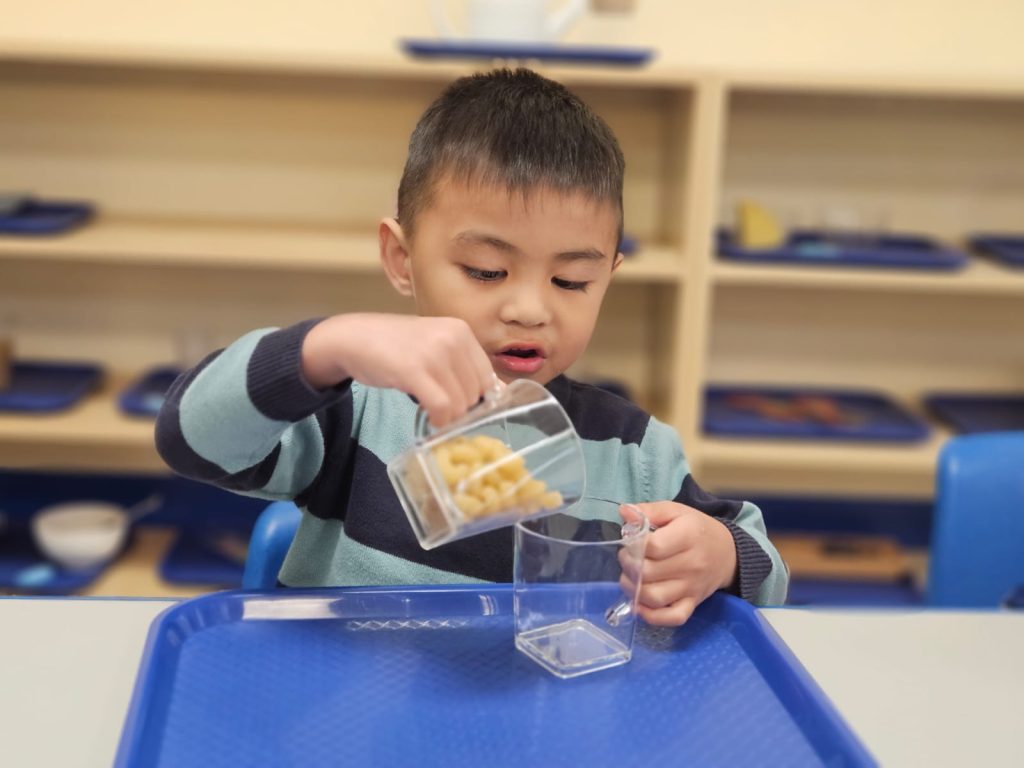 Student doing a 'Montessori job,' in our Sunnyvale preschool campus.