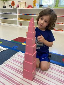 a child at a preschool campus playing with blocks in Hercules, California