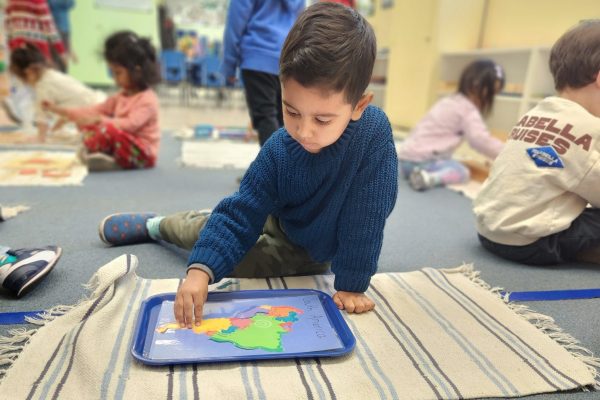 A boy in a Pleasanton California kindergarten, learning.